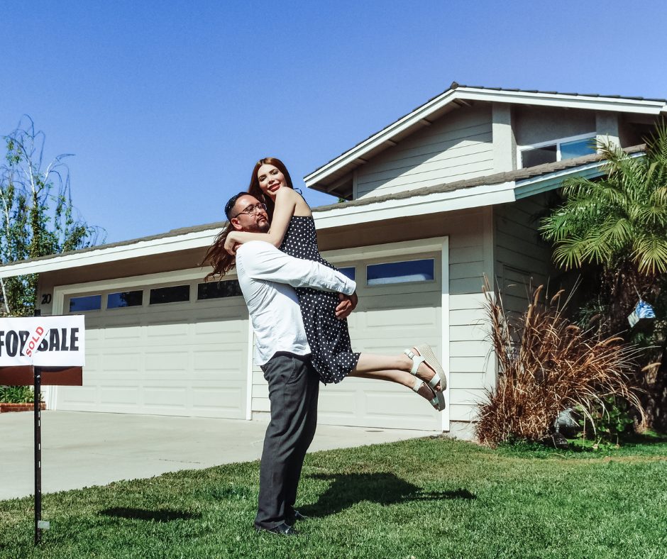 Couple celebrating buying their first home.